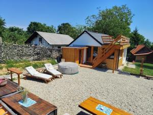 a patio with chairs and a house in the background at Casa33 in Dobrovnik