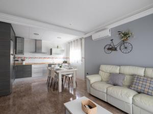 a living room with a white couch and a table at Villa Victor in Riumar