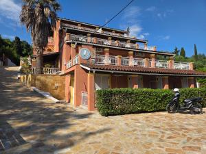 a house with a motorcycle parked in front of it at Corfu Paloma Apartments in Ipsos