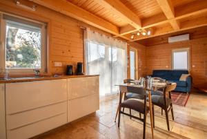 a kitchen and dining room with a table and chairs at Chalet des Épicéas in Chorges