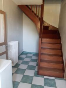 a staircase in a room with a checkered floor at chambres nature in La Celle-sous-Gouzon