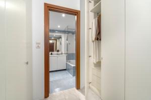 a bathroom with a mirror and a sink and a tub at Riviera by Urban Luxy in Athens +11 photos