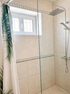 a shower with a glass door in a bathroom at chambres nature in La Celle-sous-Gouzon