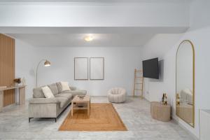 a living room with a couch and a table at Riviera by Urban Luxy in Athens