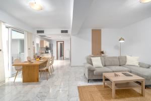 a living room with a couch and a table at Riviera by Urban Luxy in Athens