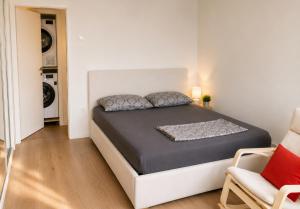 a bedroom with a bed in a white room at Athena in Koper