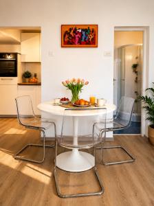 a white table and chairs in a room at Athena in Koper