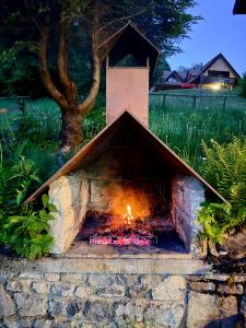 a brick oven with a fire inside of it at Casa vacanze Ravascletto in Ravascletto