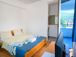 a bedroom with a bed and a computer on a desk at Villa Apollo Ohrid Lakeside in Ohrid
