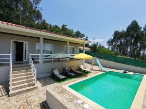 a villa with a swimming pool and a house at Casal do Porto - Um refugio de férias in Vila Verde