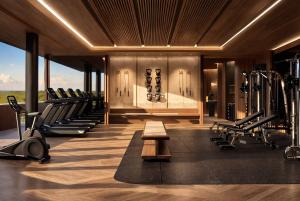 a gym with rows of exercise equipment and a bench at Twinpalms Treehouses Phuket in Bang Tao Beach