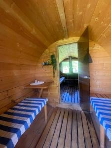 a sauna with two benches in a wooden room at Lahemaa Glamping in Viinistu