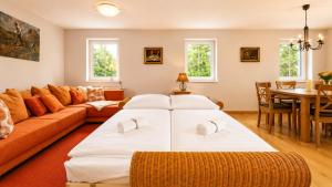 a living room with a large bed and a couch at Chalet am Berg Turracher Höhe Natur & Ski in Turracher Hohe