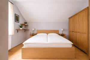 a bedroom with a large bed with a wooden headboard at Chalet am Berg Turracher Höhe Natur & Ski in Turracher Hohe +17 photos