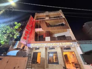 a building with a lot of lights on it at Shri Gopal Durga Dham Hotel And Restaurant in Ujjain
