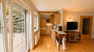 a kitchen with a large window and a kitchen with a counter at Chalet am Berg Turracher Höhe Natur & Ski in Turracher Hohe