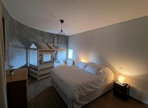 a bedroom with a bed and a mirror and a staircase at Saisonnée - Gîtes de Charme en Aveyron in Centrès