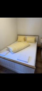 a bed with yellow sheets and a book on it at Apartment MICKEY in Interlaken
