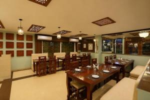 a dining room with tables and chairs in a restaurant at Hotel Luxury Stay Igi Airport Delhi in New Delhi +93 photos