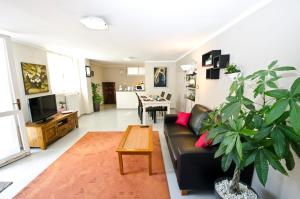 a living room with a black couch and a table at Parco Delle Valli in Sassari