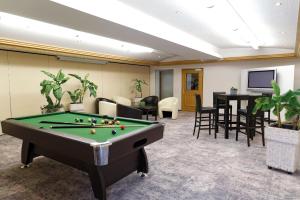 a billiard room with a pool table and chairs at Trip Inn Landhotel Krone in Roggenbeuren