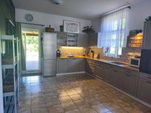 a kitchen with stainless steel appliances and a tile floor at Vila Rychleby Javorník in Javorník