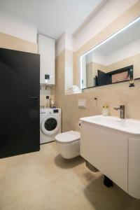 a bathroom with a toilet sink and a washing machine at Loco Studio Apartments - Private Entrance & Self Check-in in Zagreb +26 photos