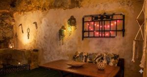 a room with a table and lights on a wall at Aloni Studio in Azoyirás