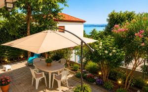 a patio with a table and an umbrella at Athena in Koper