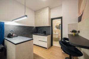 a kitchen with a sink and a counter in a room at Loco Studio Apartments - Private Entrance & Self Check-in in Zagreb
