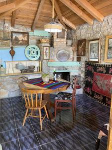 a kitchen with a table and chairs and a fireplace at Vila Agroturizam Kućica Mostar in Mostar