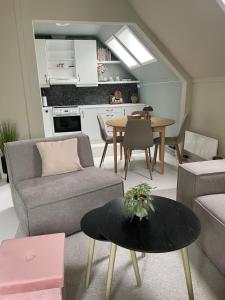 a living room with a couch and a table at High rated private appartment 350 m from Ålesund center with free parking in Ålesund +21 photos