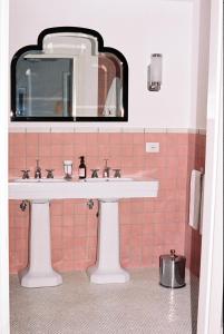 a bathroom with a sink and a mirror at Il Capri Hotel in Capri