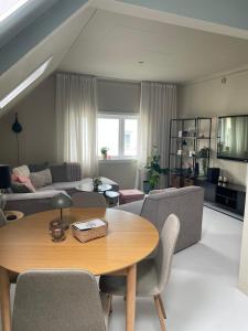 a living room with a table and a couch at High rated private appartment 350 m from Ålesund center with free parking in Ålesund