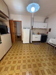 a kitchen with a refrigerator and a table in it at Vecchio Mulino-Ceci's Flat in Entracque