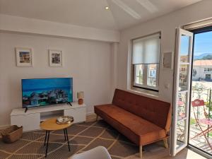 a living room with a couch and a tv at Casa da Villa in Monção