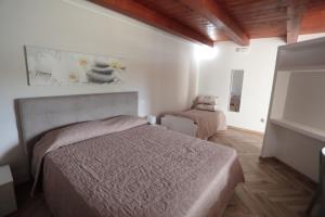 a bedroom with a bed and a chair in it at Casa Vacanze Villa Stella in Sambiase