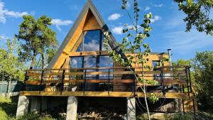 a tree house with a pitched roof at Secluded A-Frame Cabin with Private Hot Tub & Views - IezerVenture in Şelari