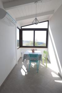 a dining room with a table and two chairs at Casa Vacanze Villa Stella in Sambiase