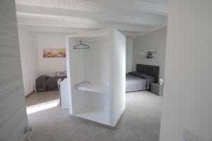 a white room with a bed and a white wall at Casa Vacanze Villa Stella in Sambiase