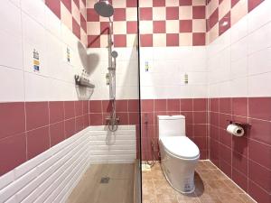 a bathroom with a shower with a toilet and a sink at Tony Resort in Patong Beach