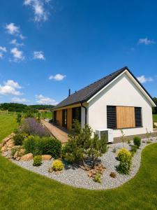 a house with a garden in front of it at Modern House with Private Pool & Terrace in Červená Třemešná