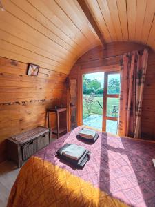 a bedroom with a bed in a room with a window at Les Gîtes de Botte in Duras