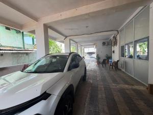 a white car parked in front of a house at Hotel Lotus Stay INN in Jabalpur