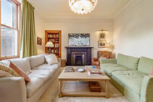 a living room with a couch and a coffee table at Hazelton Townhouse - Crail in Crail