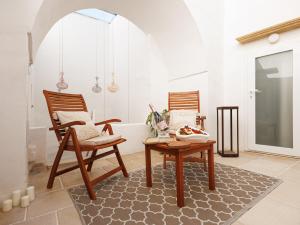 two wooden chairs and a table in a room at Grotta Sancta Suite&SPA in Gallipoli