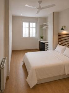 a bedroom with a white bed and a window at Hotel Peña Pintada by Vivere Stays in Lañada +1 photo
