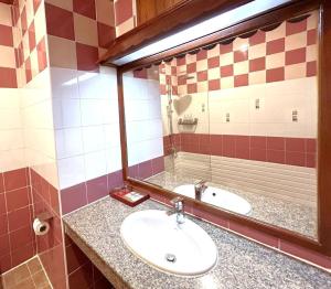 a bathroom with two sinks and a mirror at Tony Resort in Patong Beach