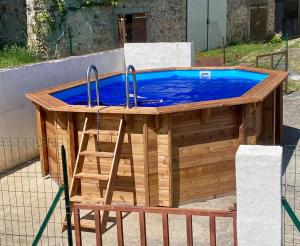a wooden pool with two faucets on top of it at Gîte champêtre LA SUITE Limousin in Saint-Yrieix-la-Perche