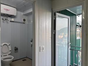 a bathroom with a toilet and a view of a city at Homestay Chân Mây in Tam Ðảo +54 photos